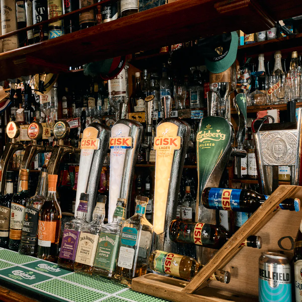 The taps along the bar — Cisk, Carlsberg and Farsons ales — with whiskey and spirits on the shelves behind