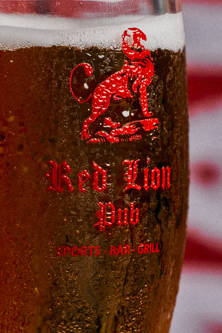 A cold pint in a Red Lion Pub glass, the red lion crest on the side